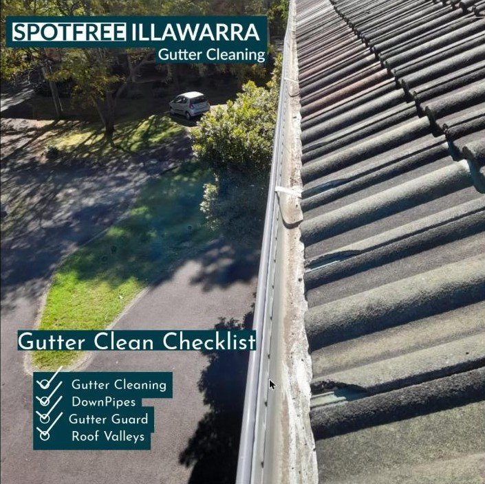 Aerial view of gutter cleaning service clearing leaves and debris from roof gutter in Wollongong